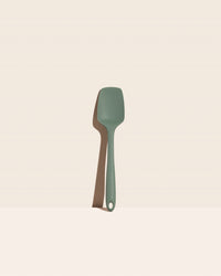 The GIR Sage Green Ultimate Spoonula on a pink background.